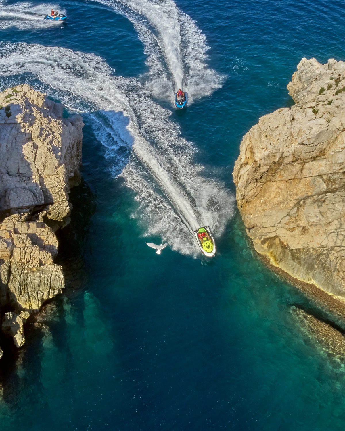 A Yamaha WaveRunner cuts across the calm Adriatic in front of Dubrovnik's Old Town walls